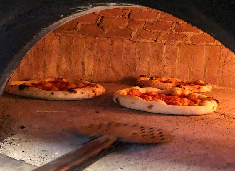 Neapolitan pizzas in the oven